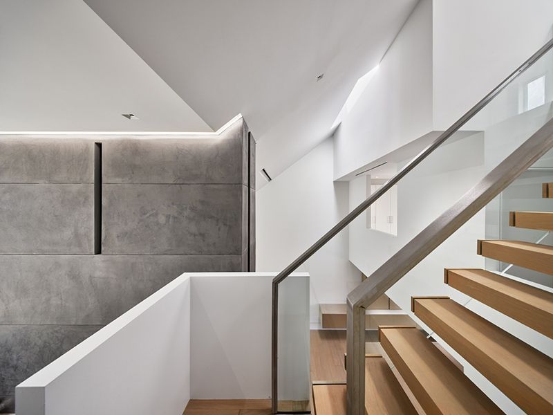 A staircase with wooden steps and a glass railing