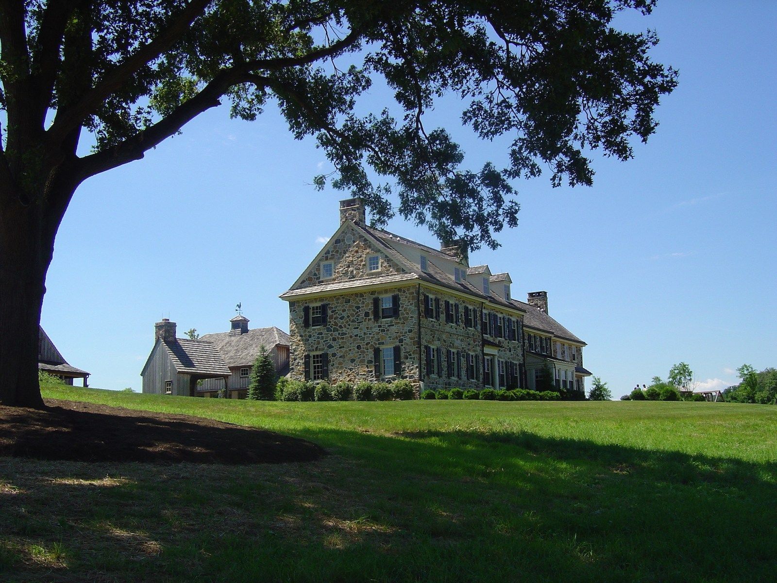A large house with a tree in front of it