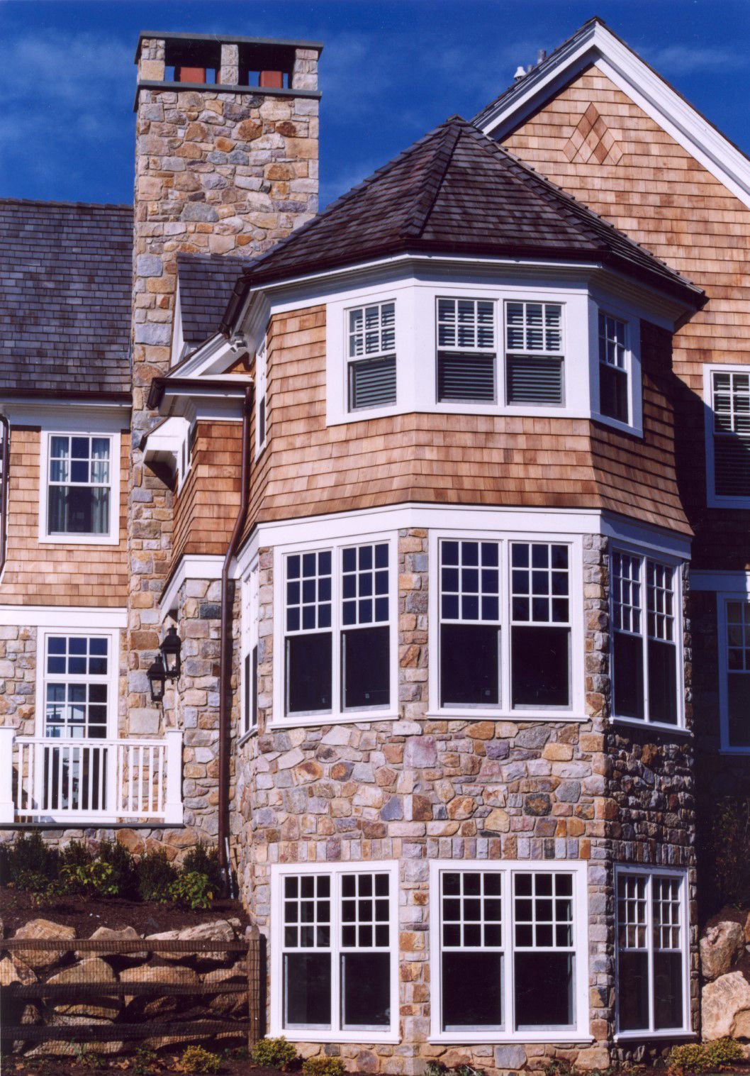 A large house with a lot of windows and a chimney