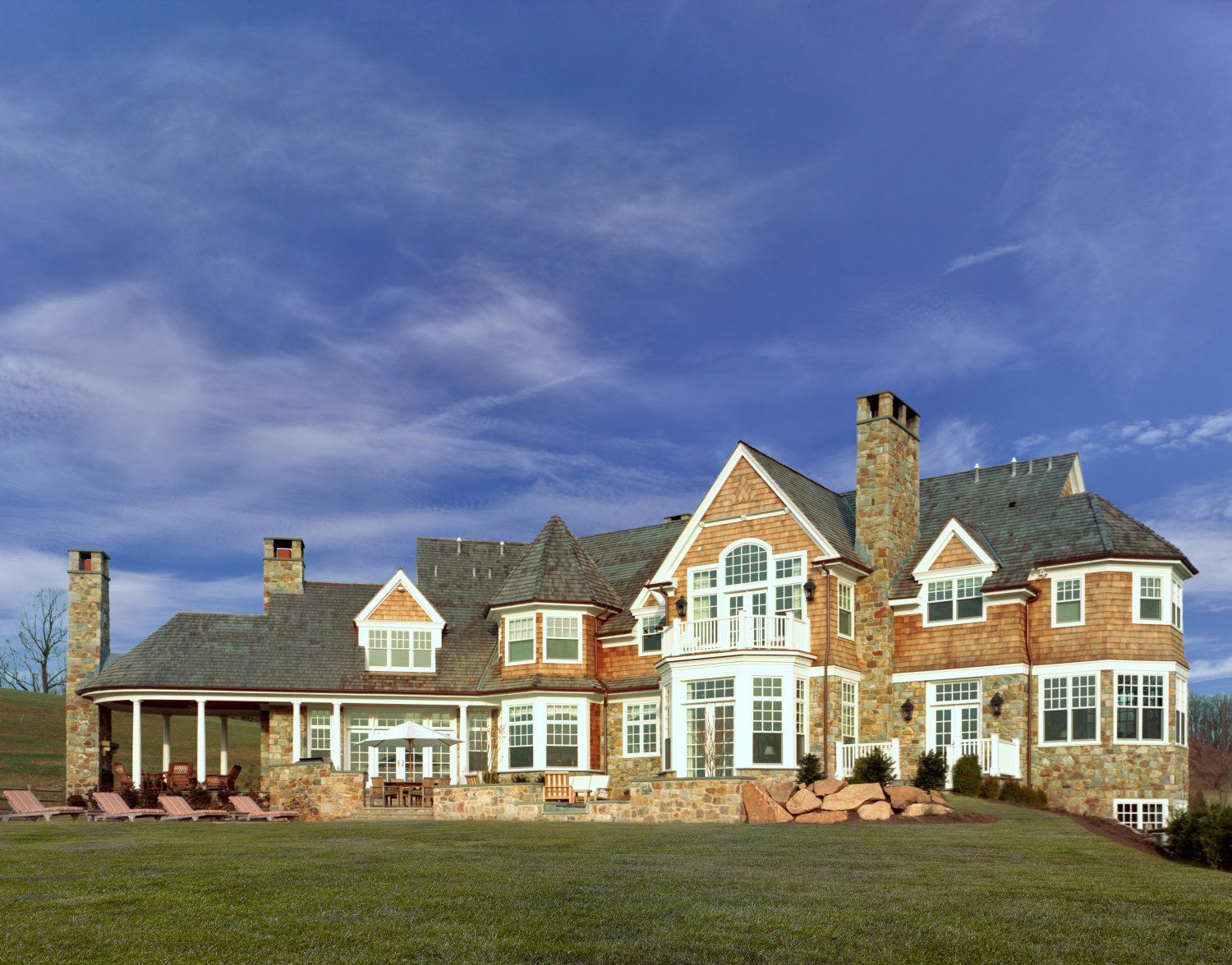 A large brick house with a blue sky in the background