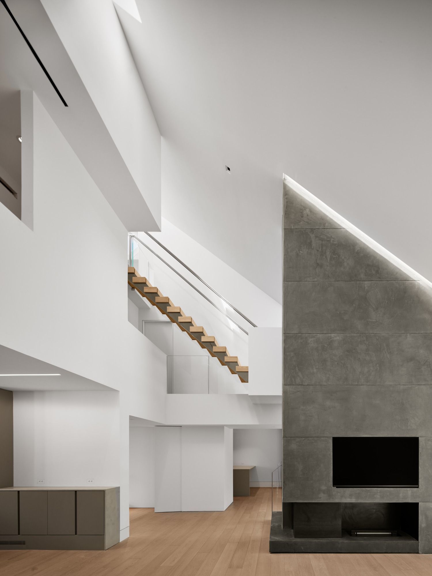 A living room with a staircase and a fireplace