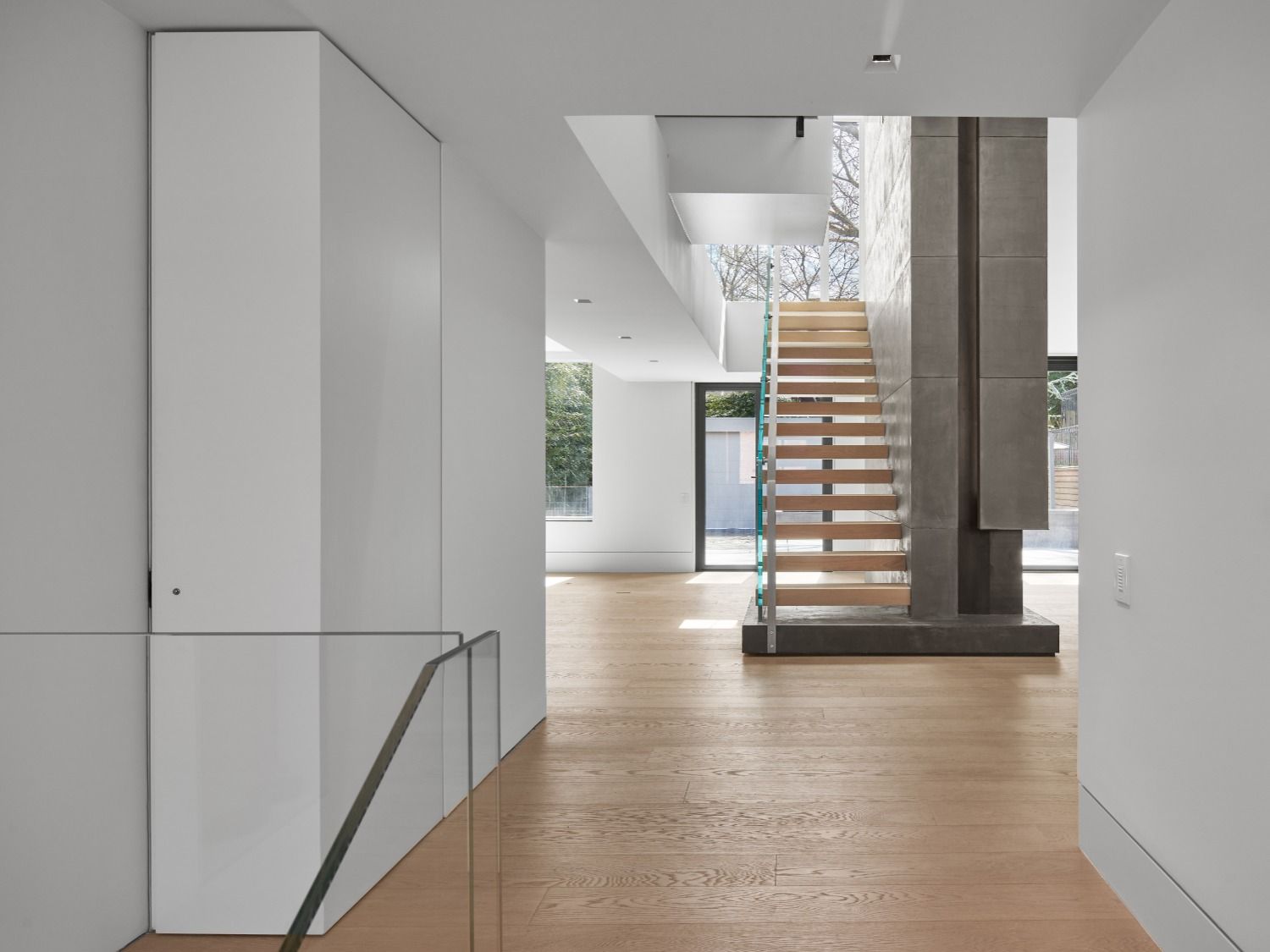 There is a staircase in the middle of the hallway.