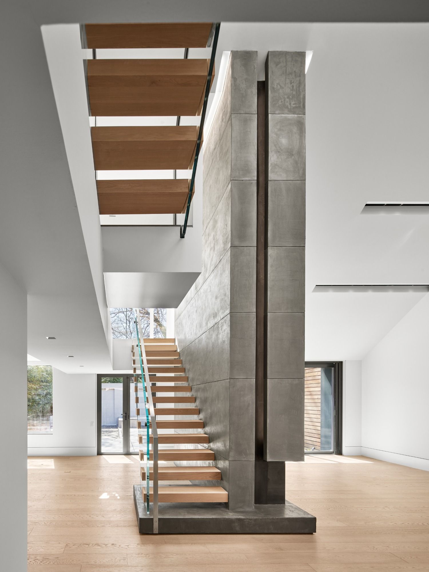 A staircase with wooden steps leading up to the second floor of a house.