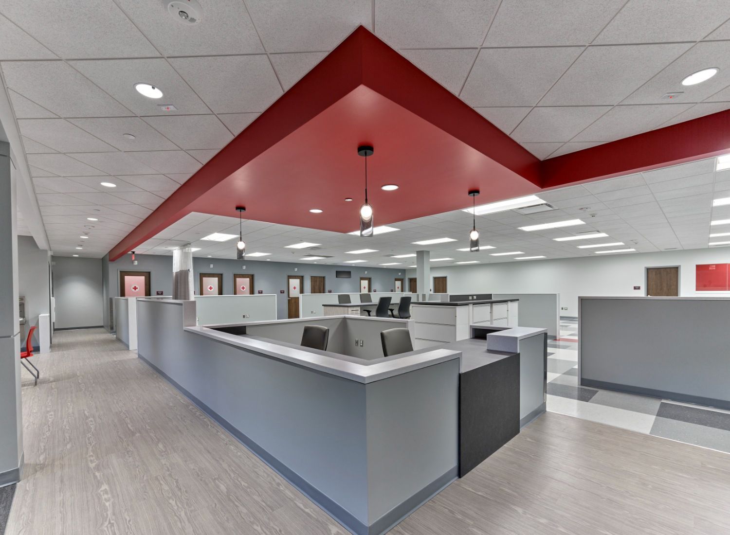 A large office with a red ceiling and cubicles