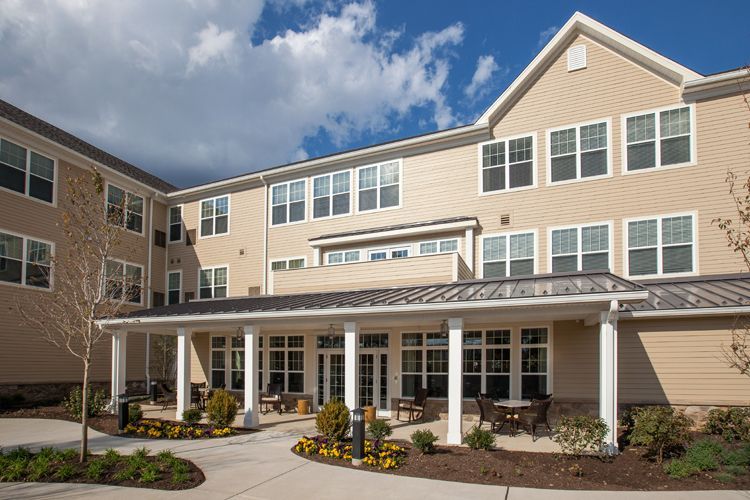 A large building with a lot of windows and a porch.