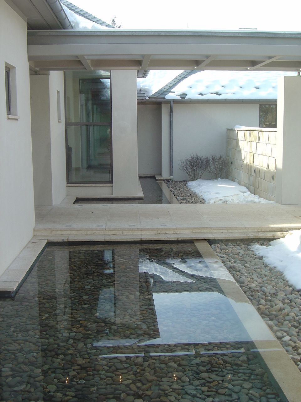 A reflection of a building in a pool of water
