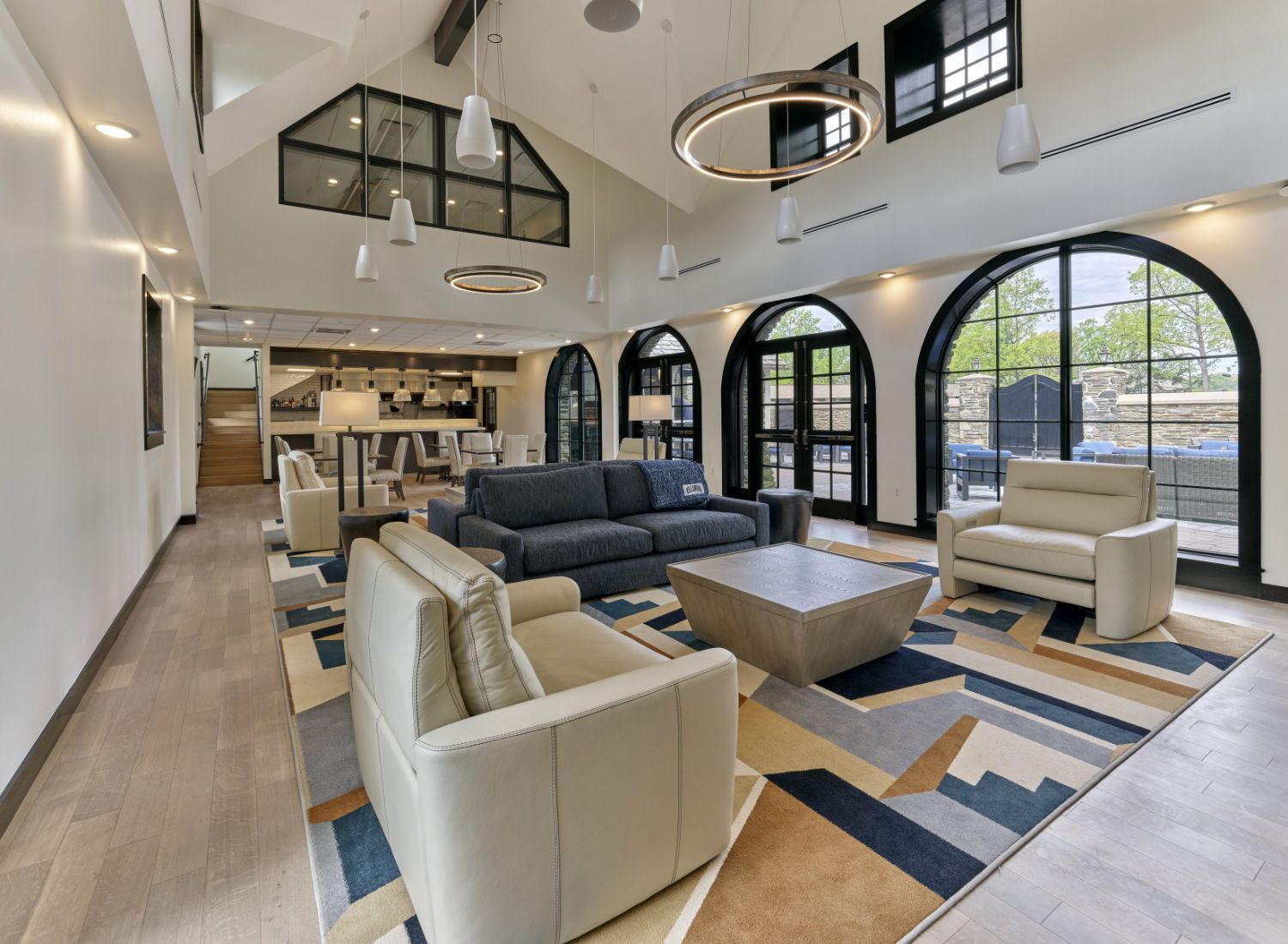 A living room with a couch , chairs , and a coffee table.