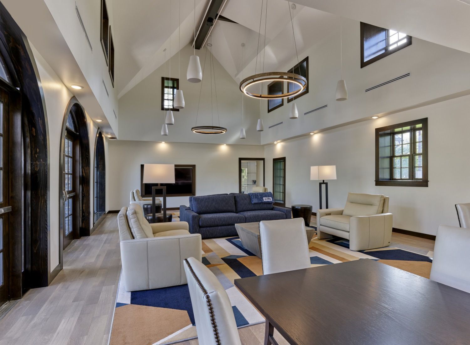 A living room with a couch , chairs , and a table.