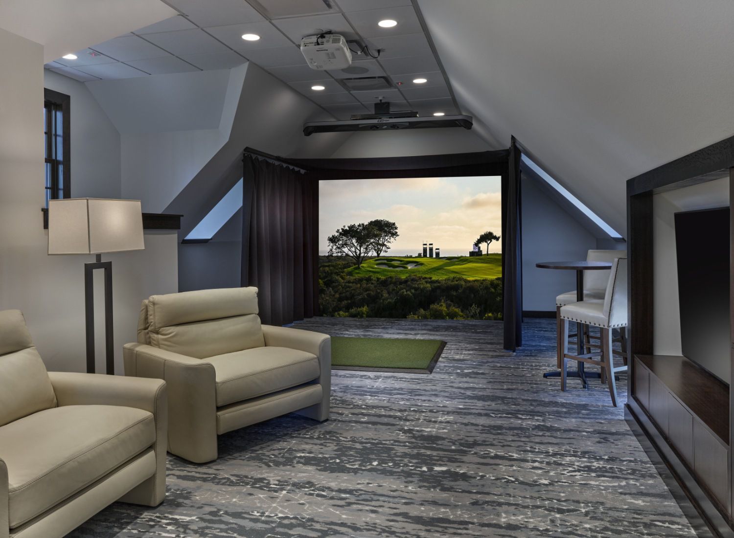 A living room with two chairs and a projector screen