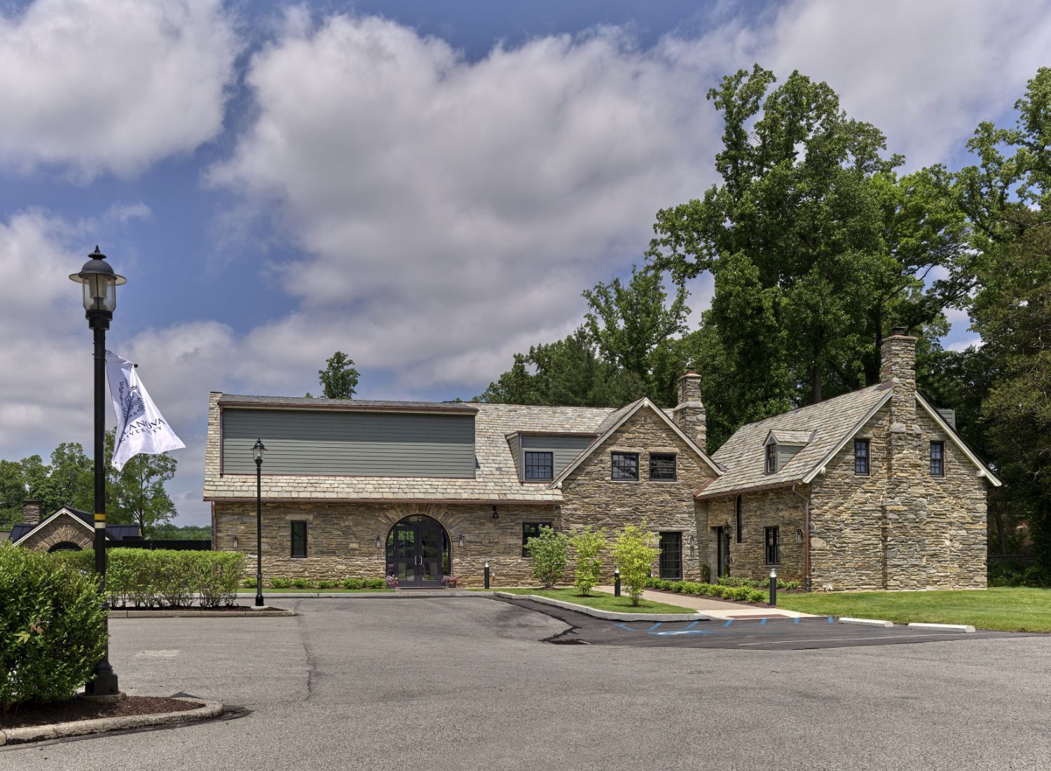 A large stone building with a flag in front of it