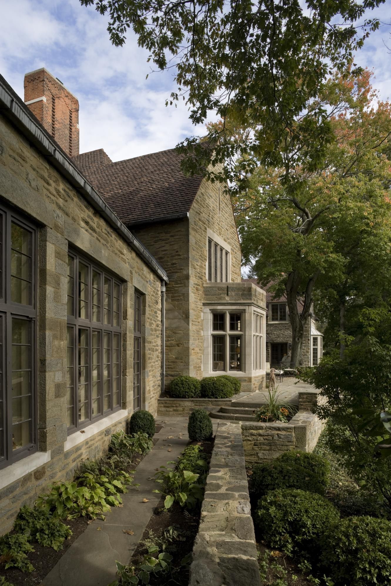 A large stone house with a stone walkway leading to it