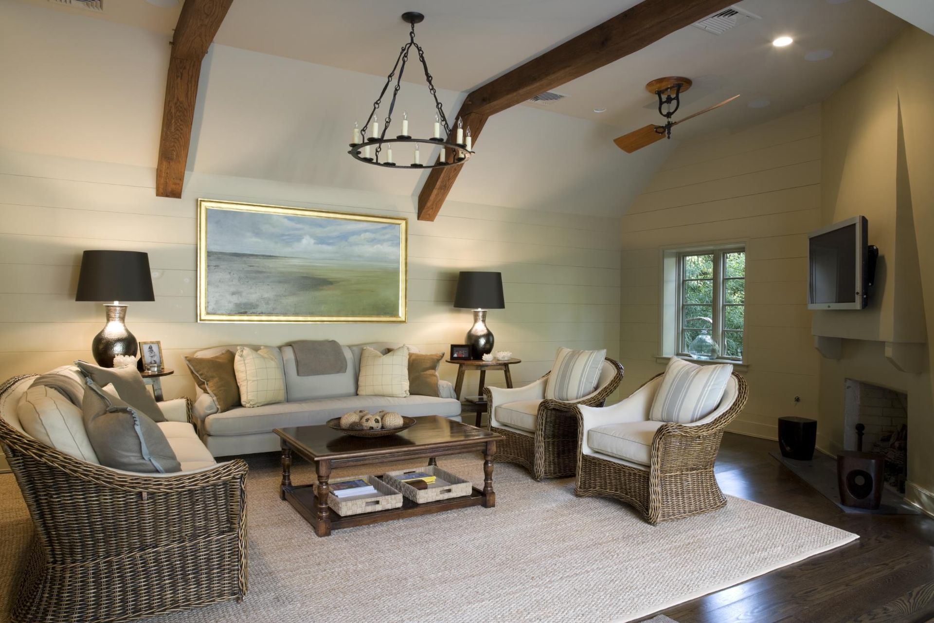 A living room with a couch , chairs , coffee table and fireplace