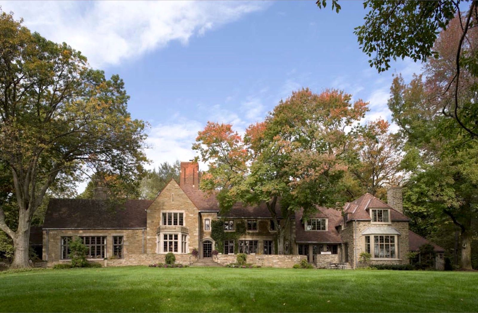A large house with a large lawn in front of it