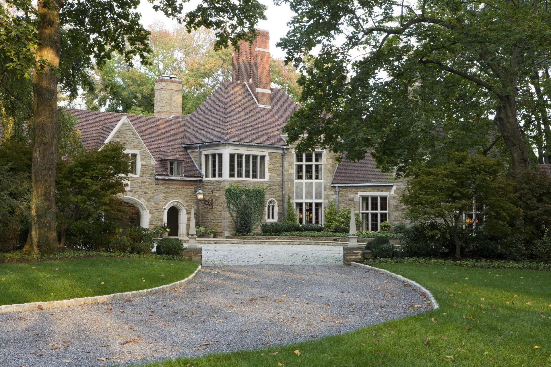 A large house with a gravel driveway leading to it