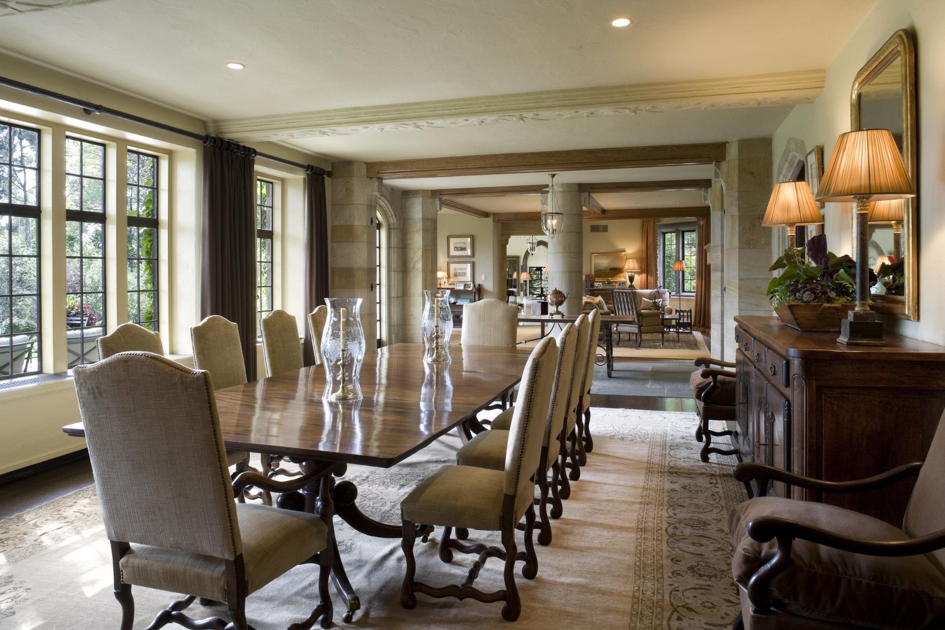 A large dining room with a long table and chairs