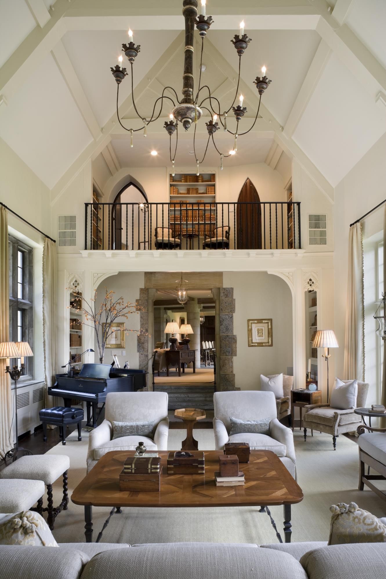 A living room with a piano and a chandelier