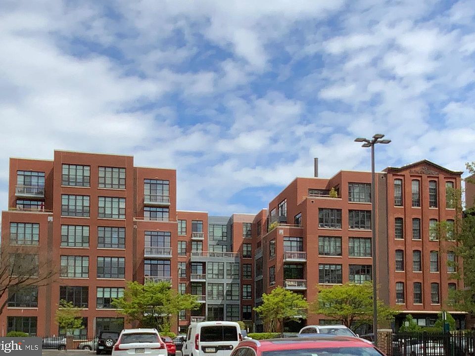 A large brick building with cars parked in front of it