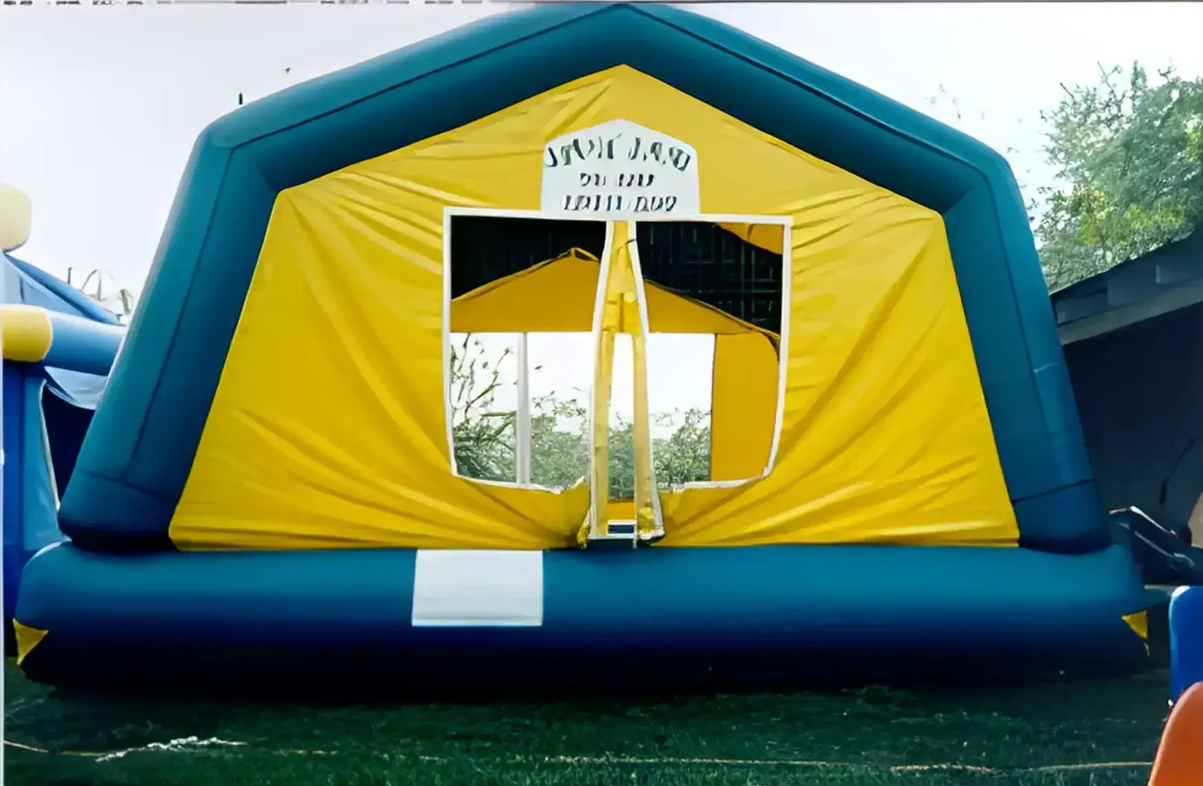 A blue and yellow inflatable tent with a sign that says water land