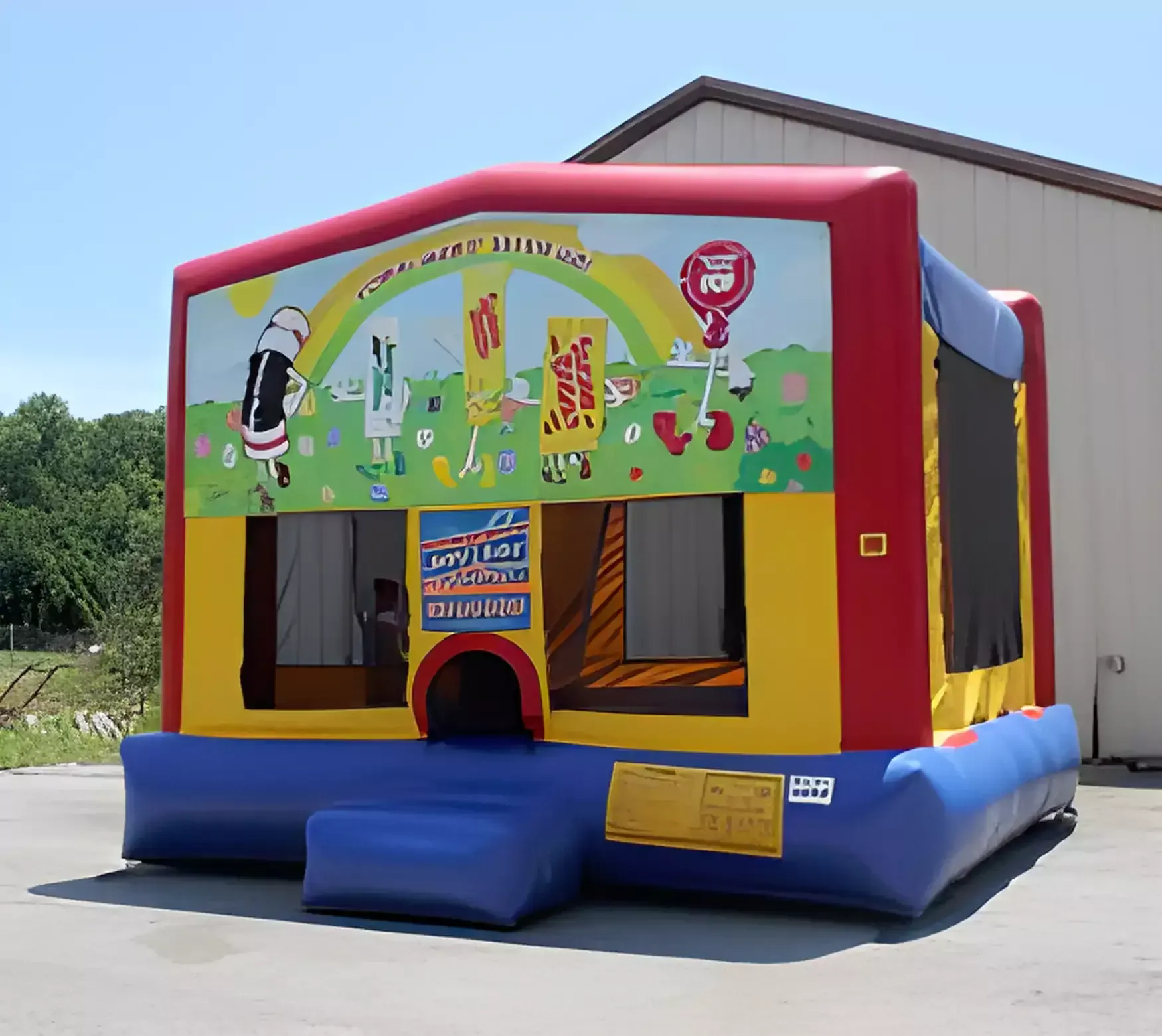 A red yellow and blue bouncy house with a rainbow on it