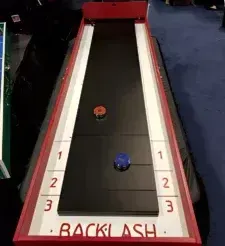 A man is playing a game called backlash on a table.