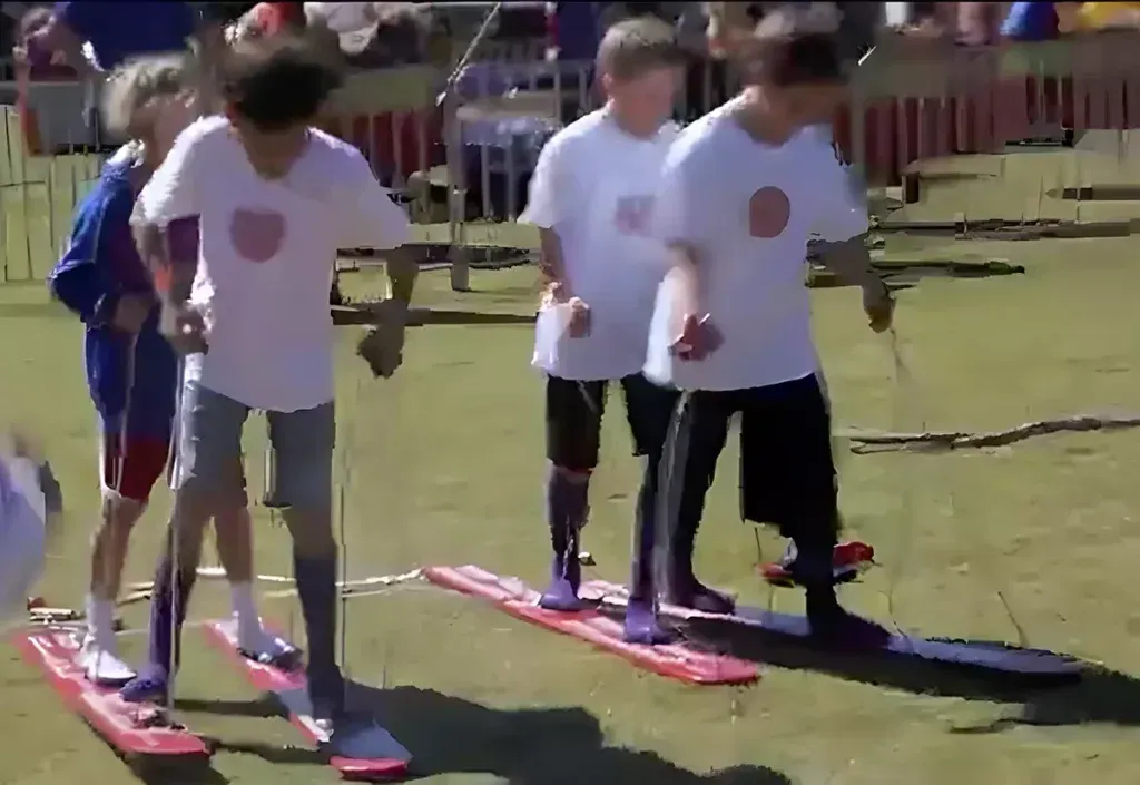 A group of people are standing on skis on a field.