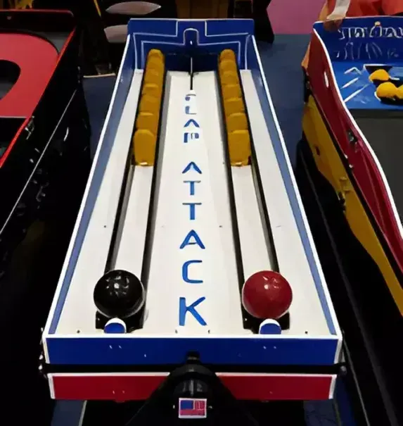 A bowling alley with a woman standing behind it