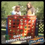 Two girls are playing a giant connect four game.