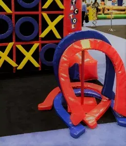 A tic tac toe game with red and blue horseshoes