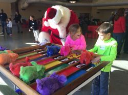 A group of children are playing a game with santa claus.