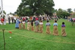 A group of people are playing a game in a park.