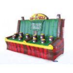 An inflatable whack a mole game is sitting on top of a table.