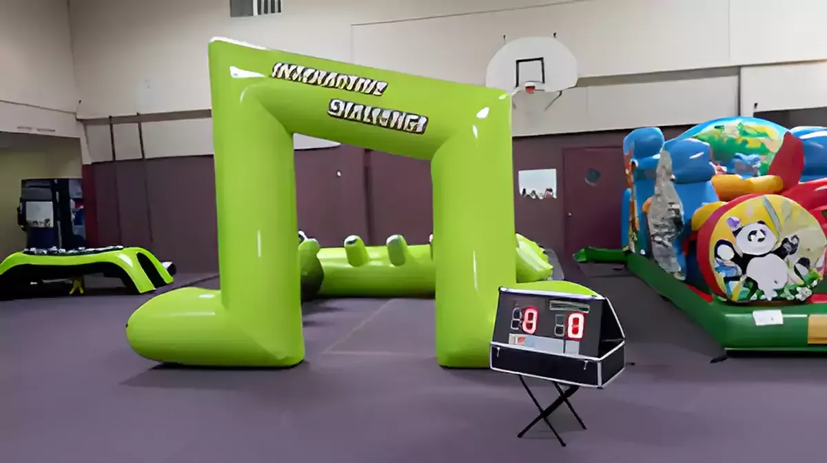 A large inflatable bouncy house with a flamingo and pineapple on it