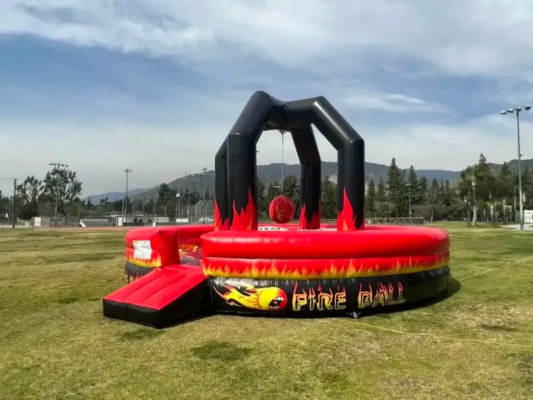 A large inflatable bouncy house with a flamingo and pineapple on it