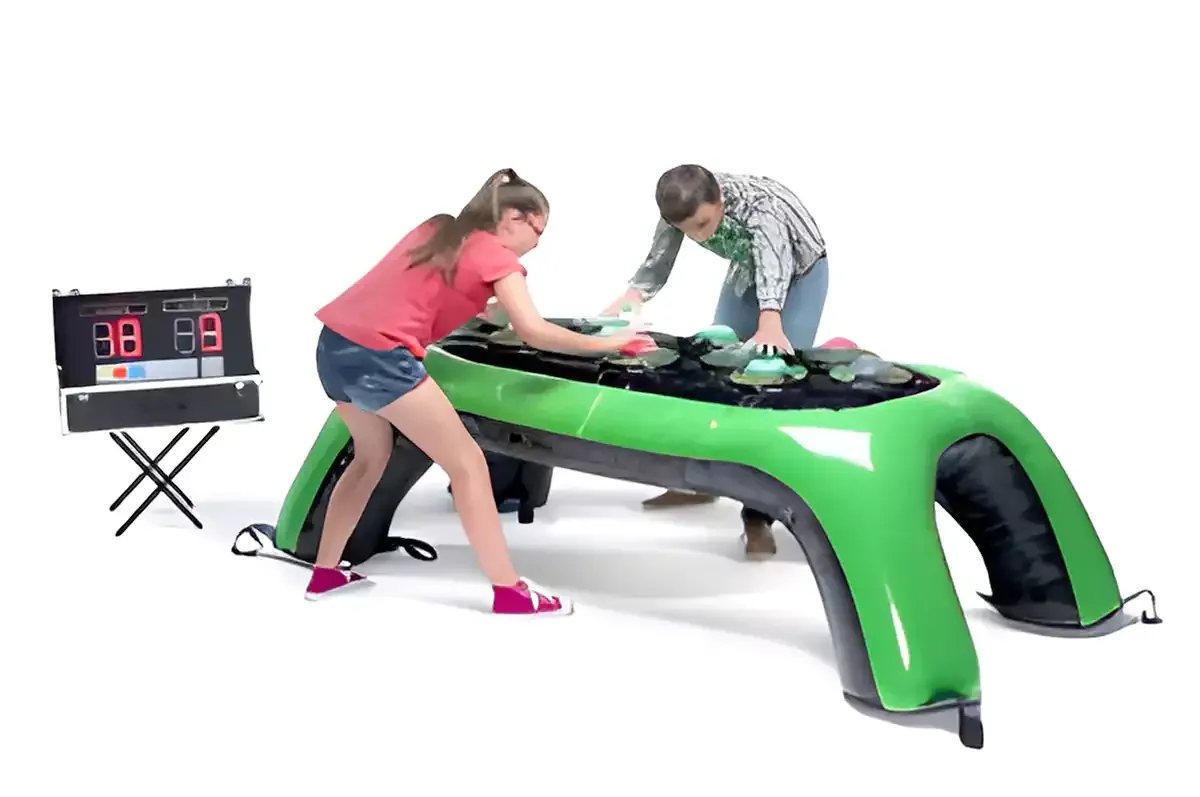 A large inflatable water slide is sitting on top of a lush green field.