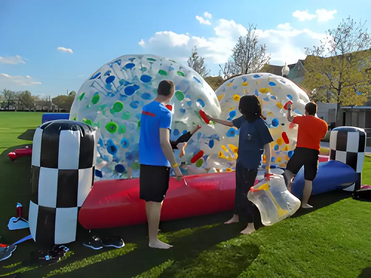 A large inflatable water slide is sitting on top of a lush green field.