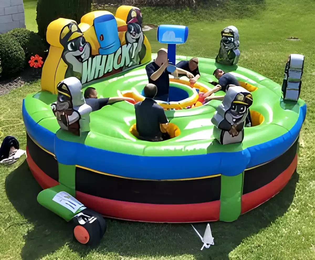 A large inflatable bouncy house with a flamingo and pineapple on it