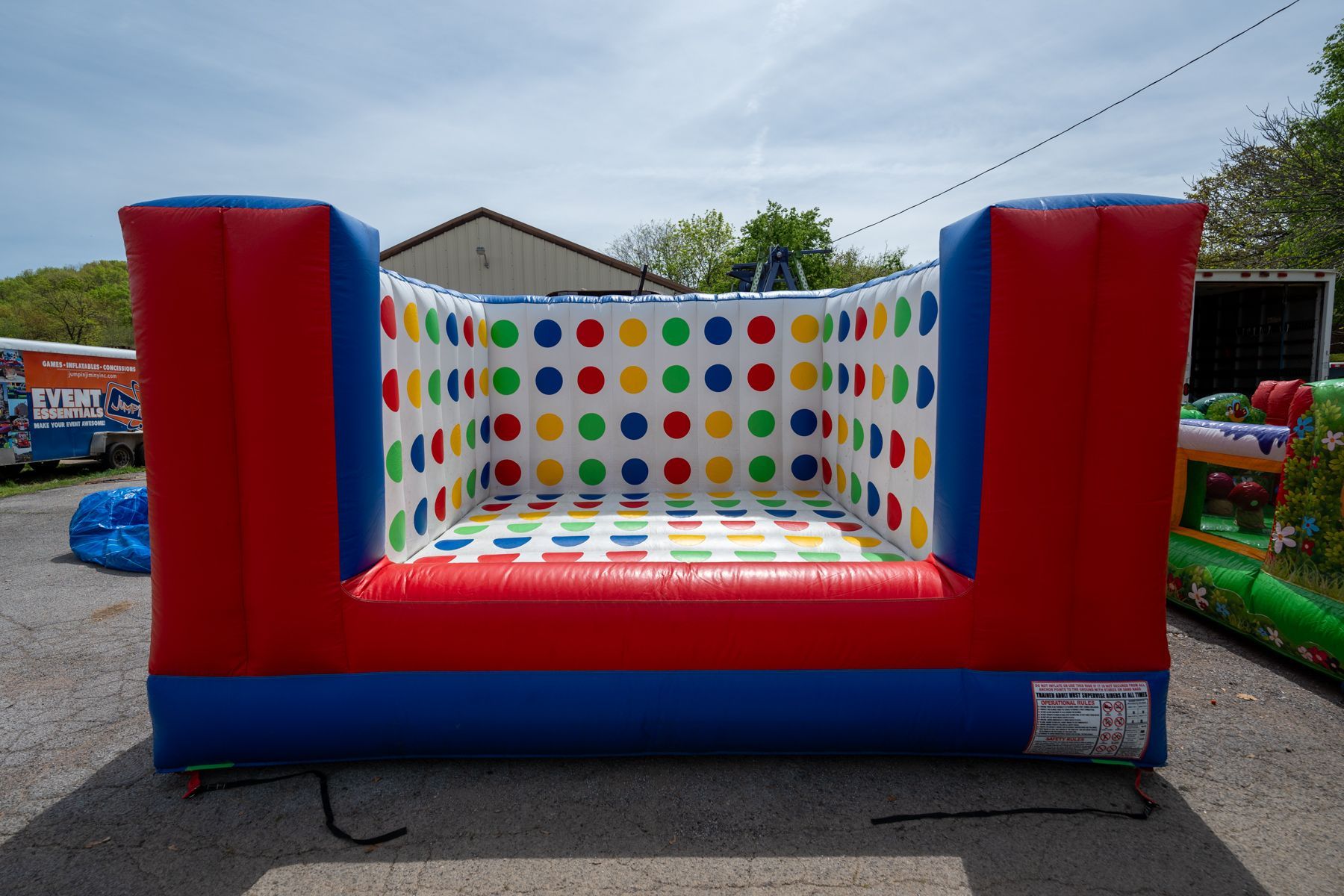 A large inflatable water slide is sitting on top of a lush green field.