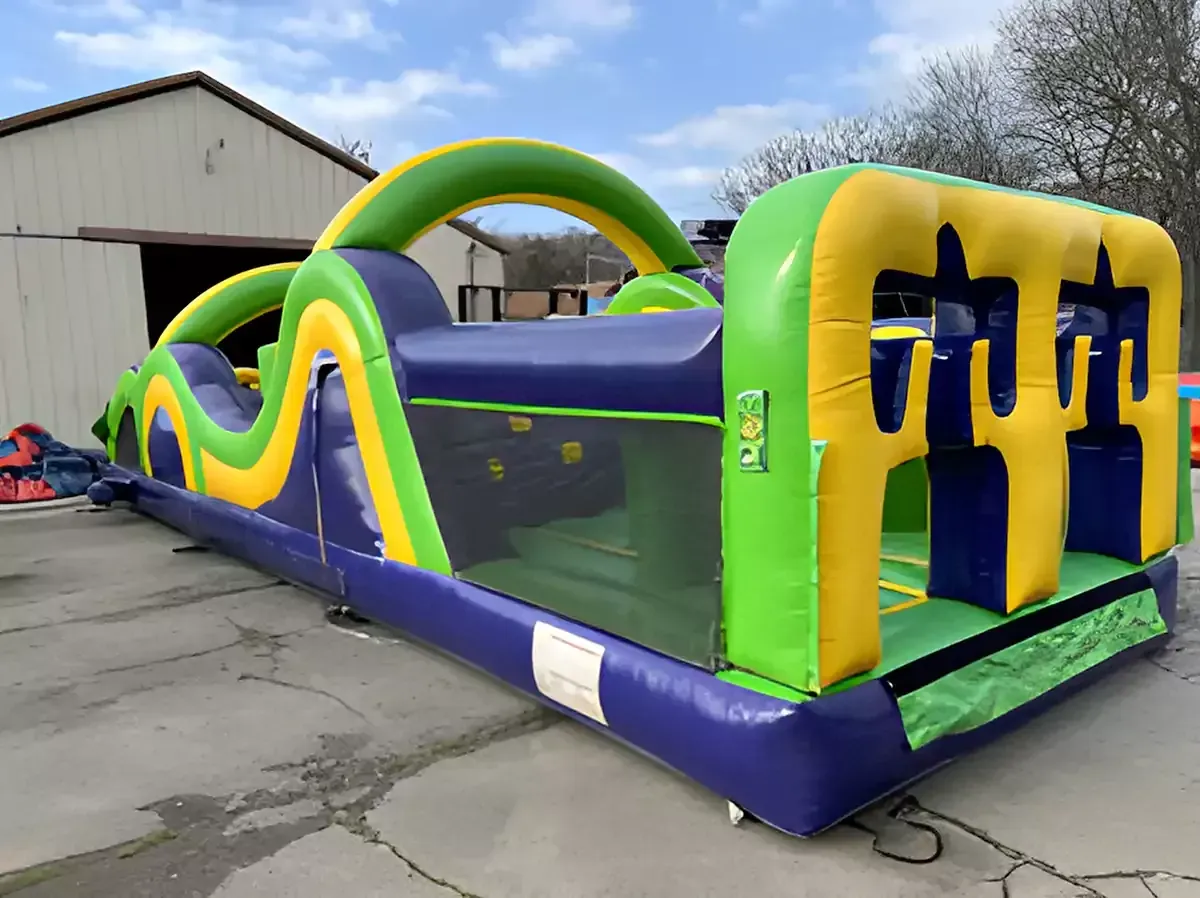 A large inflatable obstacle course is sitting in front of a building.