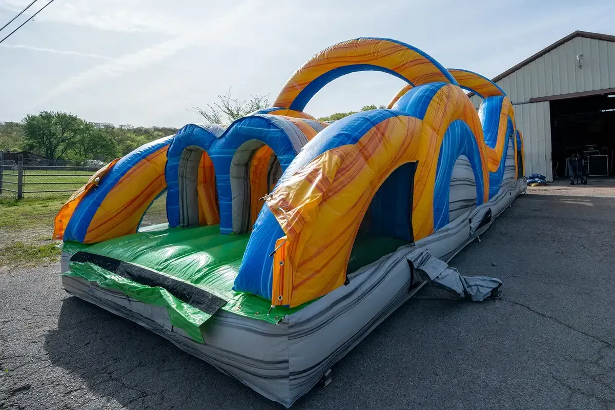 A large inflatable water slide is sitting in front of a building.
