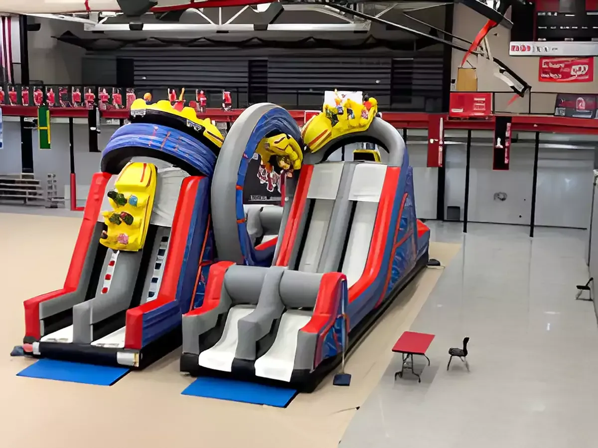 A large inflatable obstacle course is sitting in a gym.