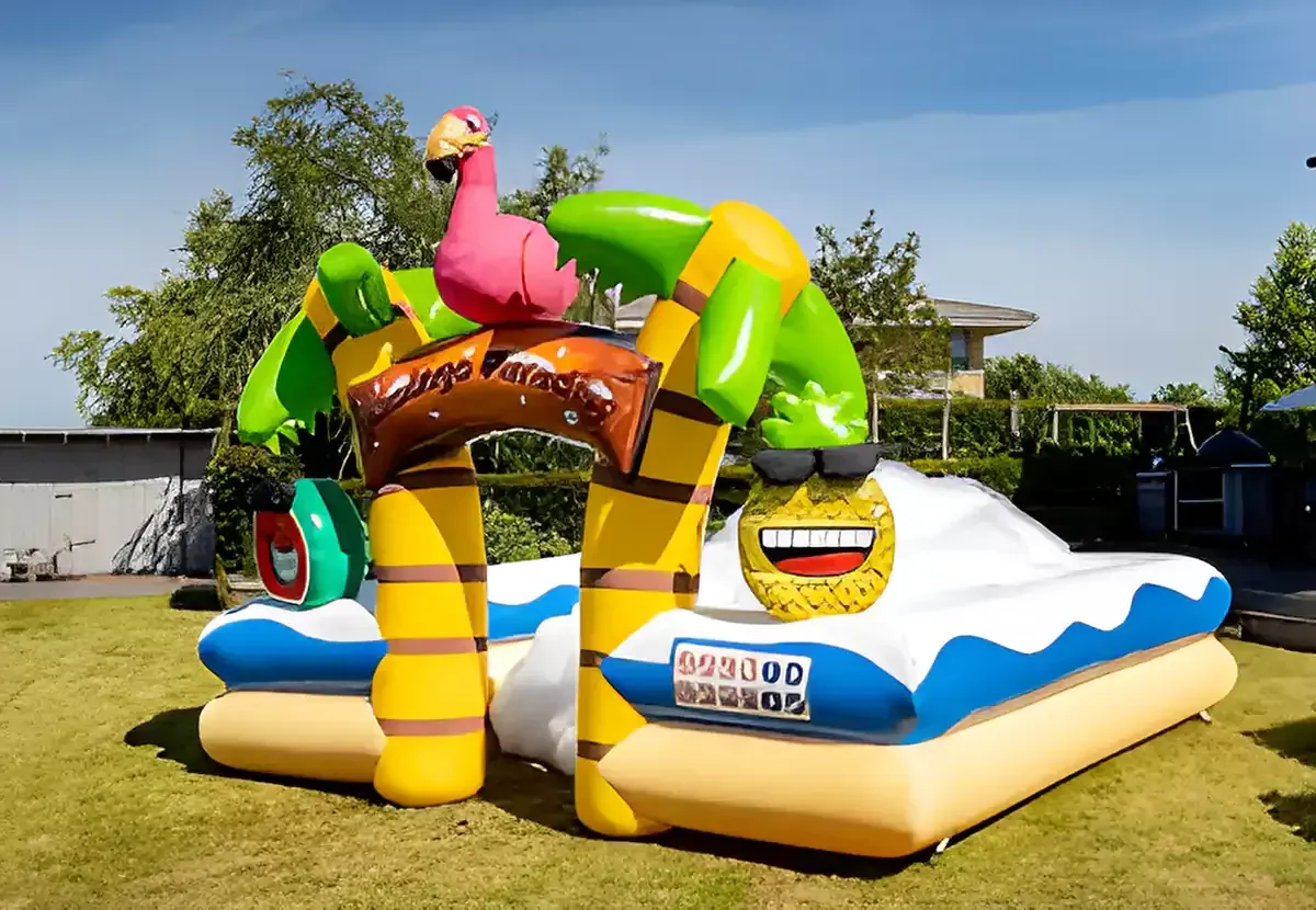 A large inflatable bouncy house with a flamingo and pineapple on it