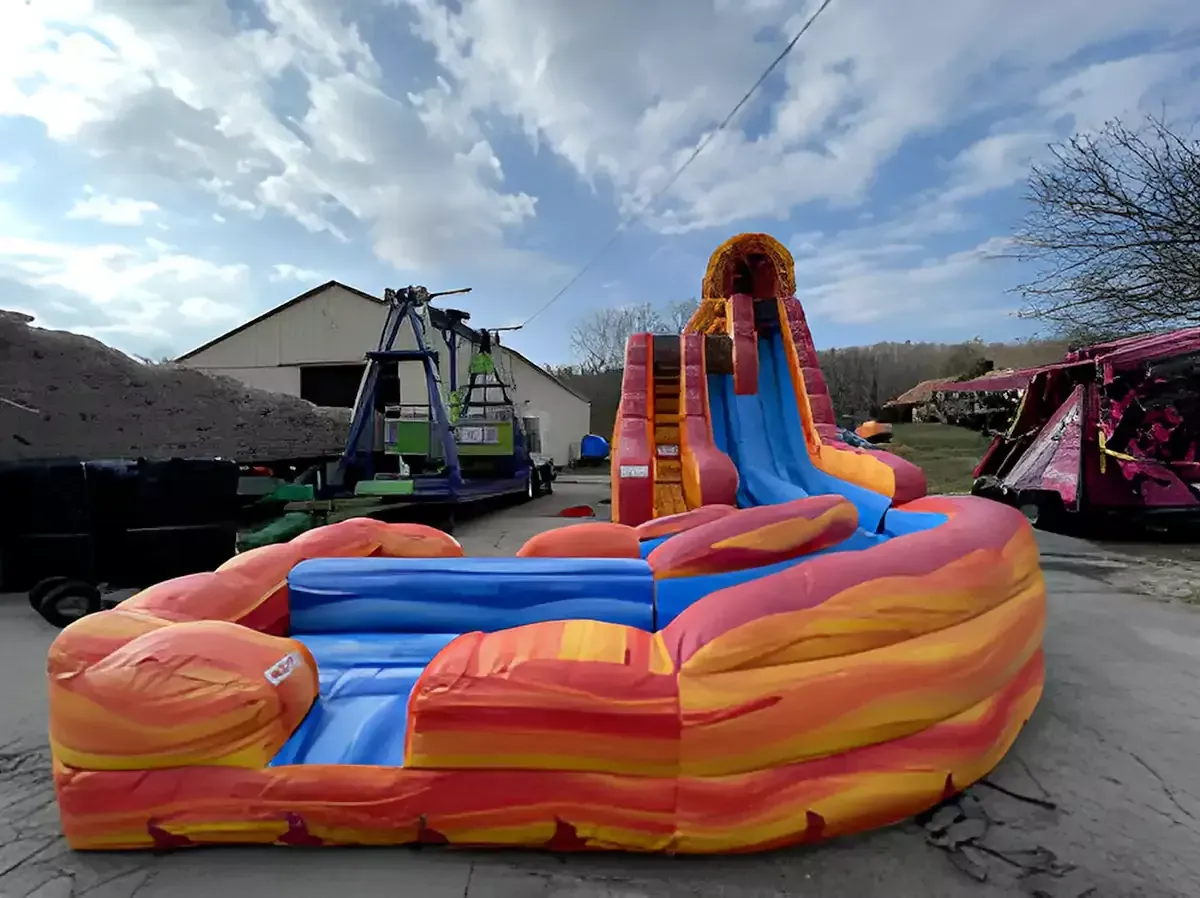 A large inflatable water slide is sitting in a parking lot.