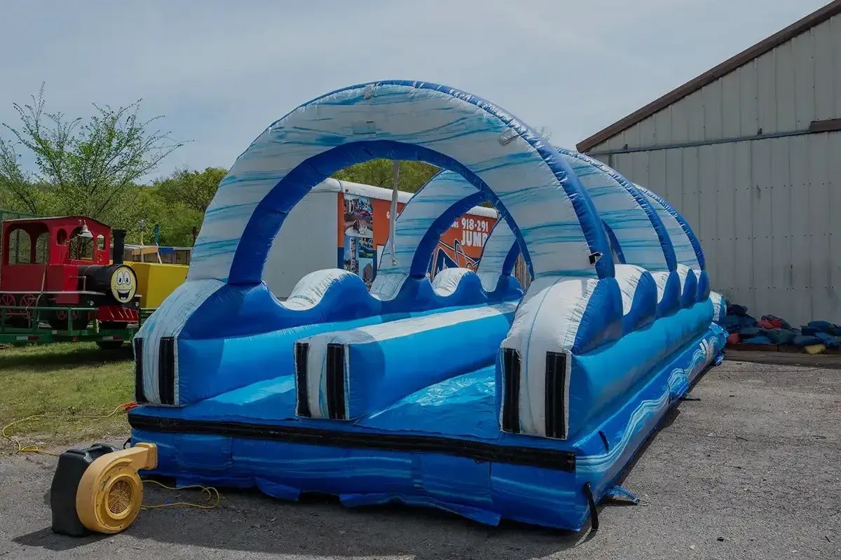 A large inflatable water slide is sitting in front of a building.
