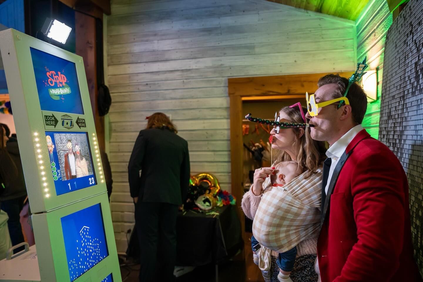 A man and woman are posing for a picture in a photo booth.