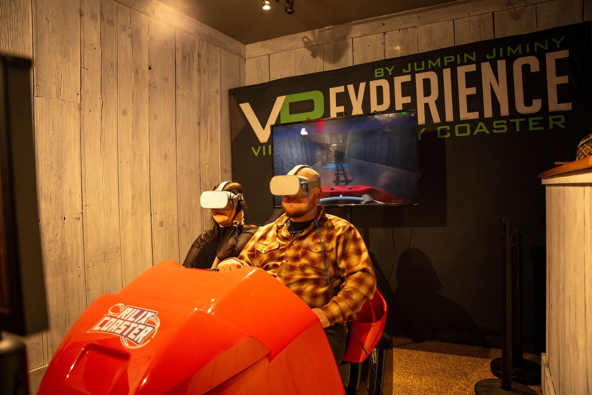 A man is sitting in a chair wearing a virtual reality headset.