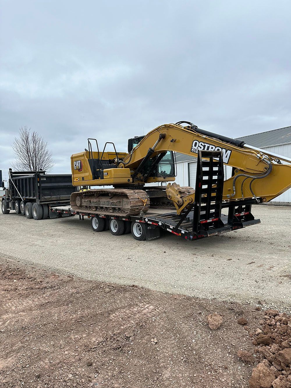 A large excavator is being transported on a trailer.