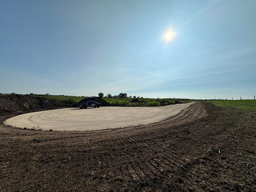 A car is parked in the middle of a dirt road.
