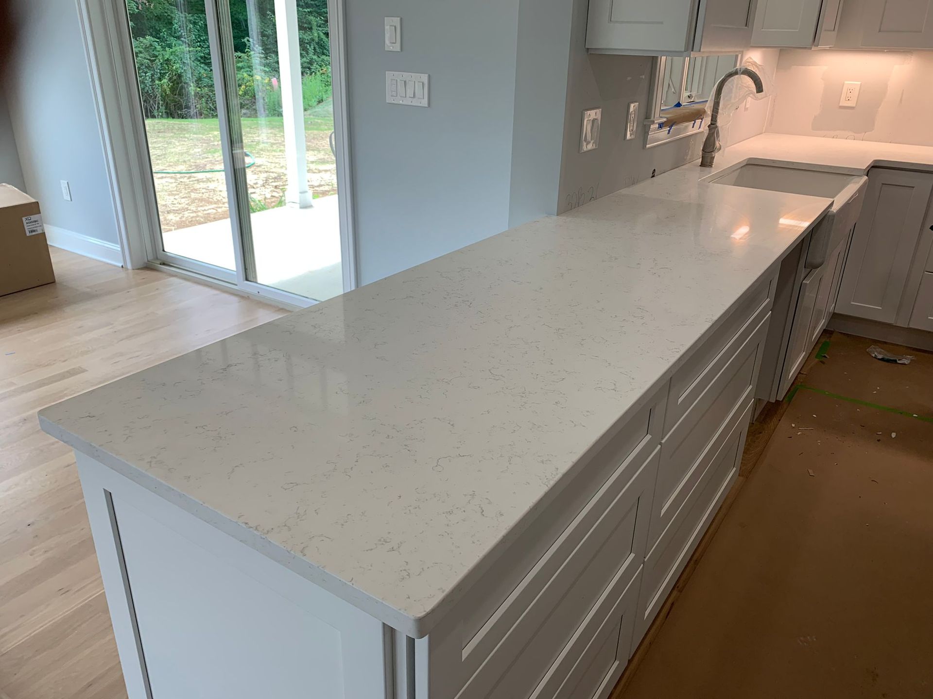 A kitchen with a large island and a sink.