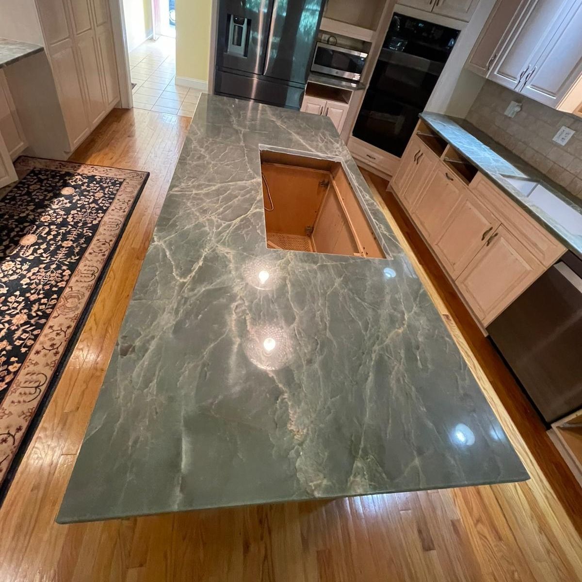A kitchen with a large granite counter top and a sink.