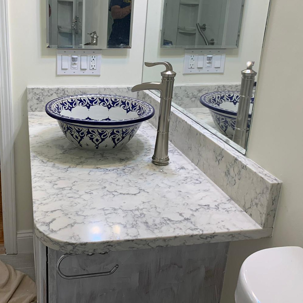 A bathroom counter with a sink and a mirror